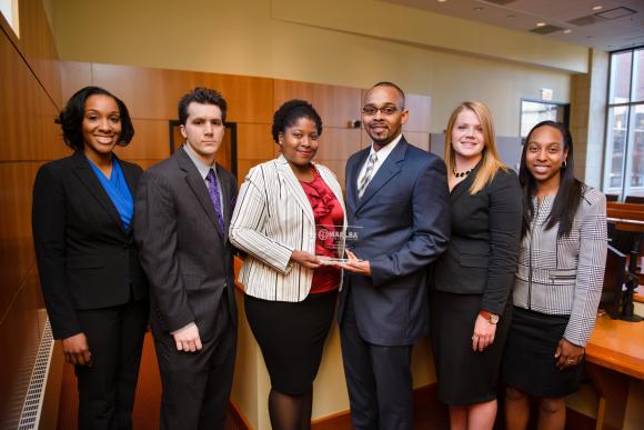Students from Camden holding an award after a moot court competition.