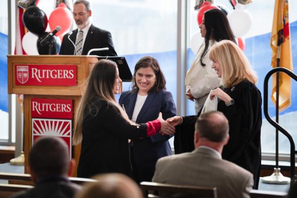 Judge shakes woman's hand at ceremony