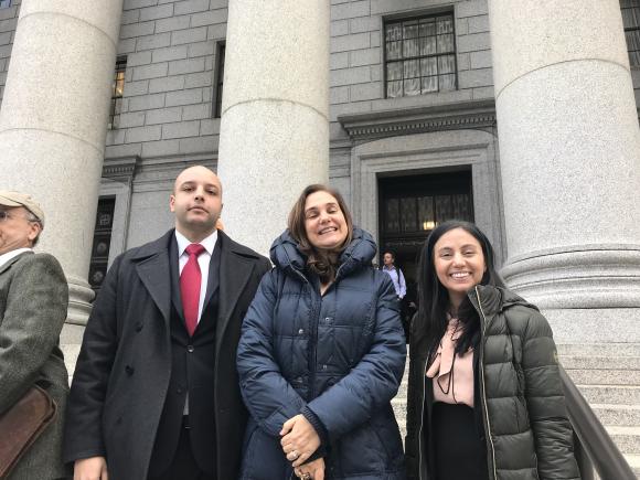 Zeyad Assaf stands with Professor Venetis and another female student on the Essex county Courthouse steps