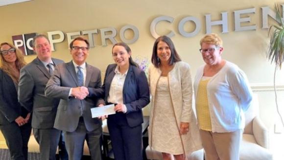 Frank Petro, senior partner of New Jersey law firm Petro Cohen P.C., recently presented a scholarship award check to Rutgers Law School student Gladys Rosario, center.