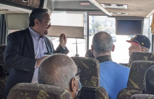 Prof. David Lopez speaking on bus during civil rights spring break trip
