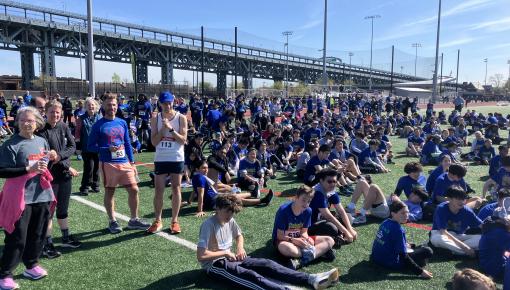 dozens of runners sitting on athletic field