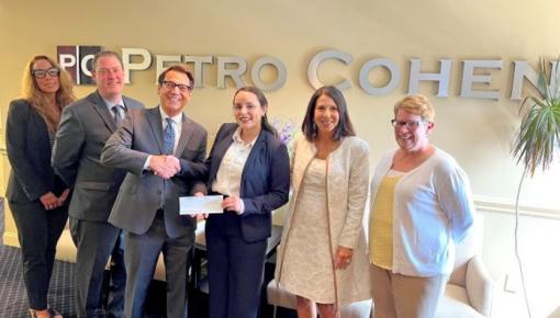 Frank Petro, senior partner of New Jersey law firm Petro Cohen P.C., recently presented a scholarship award check to Rutgers Law School student Gladys Rosario, center.