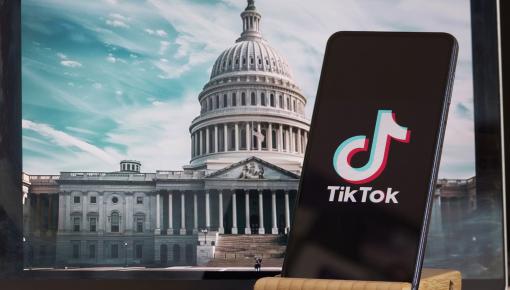 Capitol building in DC with image of cellphone with tiktok logo on screen